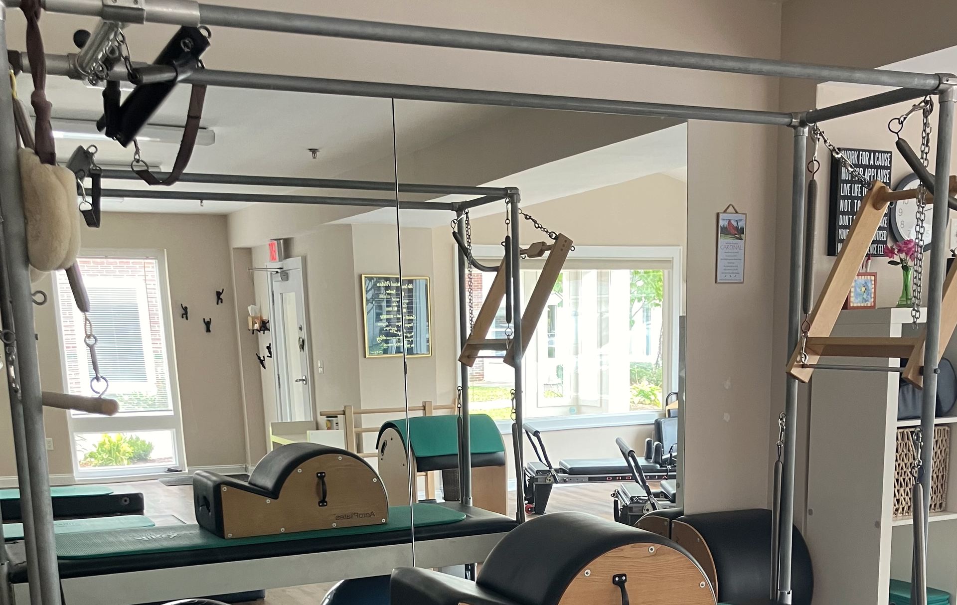 The Cadillac frame, hanging bars and mirrored wall at Essex Pilates & Wellness.