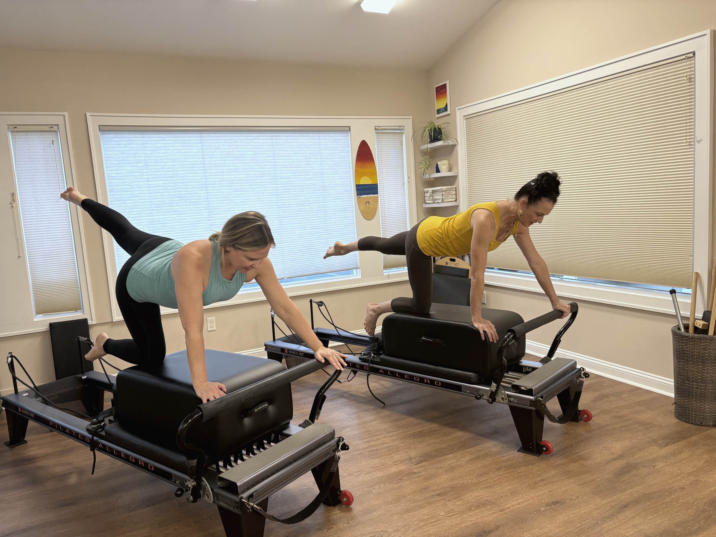 Nicole and a client practicing Pilates together in the studio.
